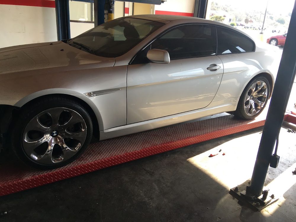Silver BMW coupe on a lift