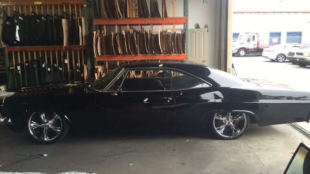 Black classic muscle car in the shop